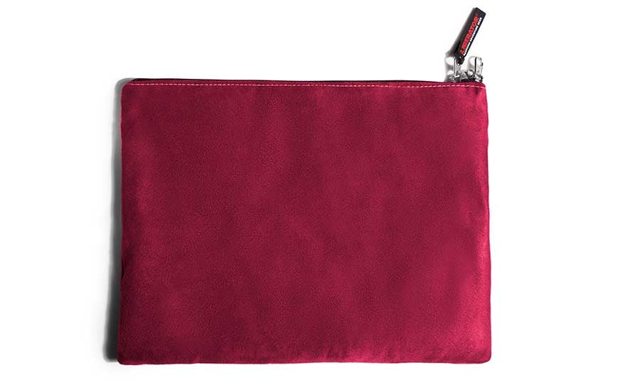A cherry microsuede toy storage bag with a zipper and a small tag.