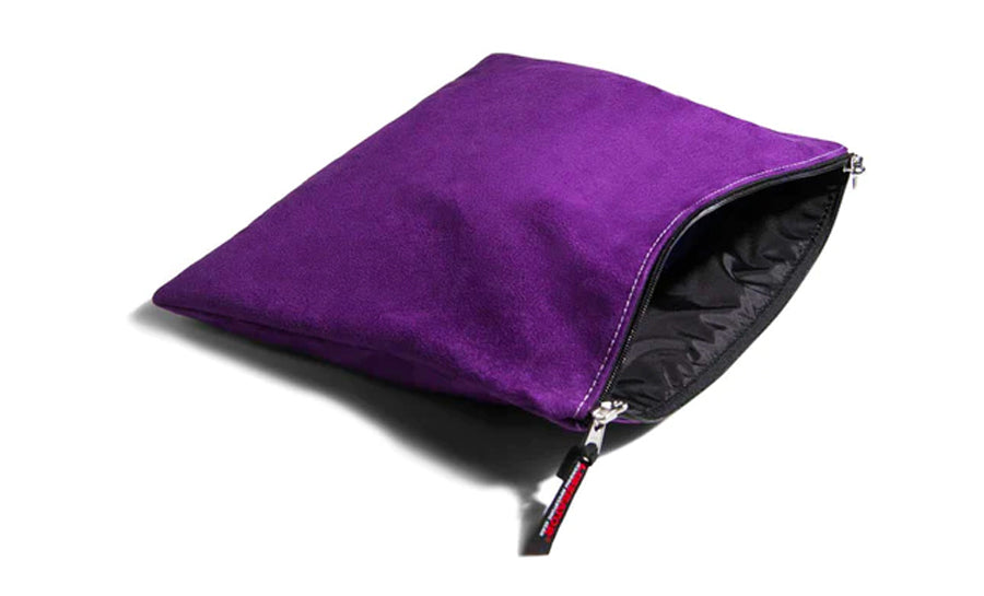 Purple microsuede travel case with an open zipper.