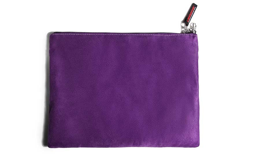 Grape microsuede travel case with a zipper and a red tag.
